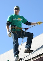 Denver Gutter Cleaning - Brian Flechsig roped off on a roof to clean the rain gutters